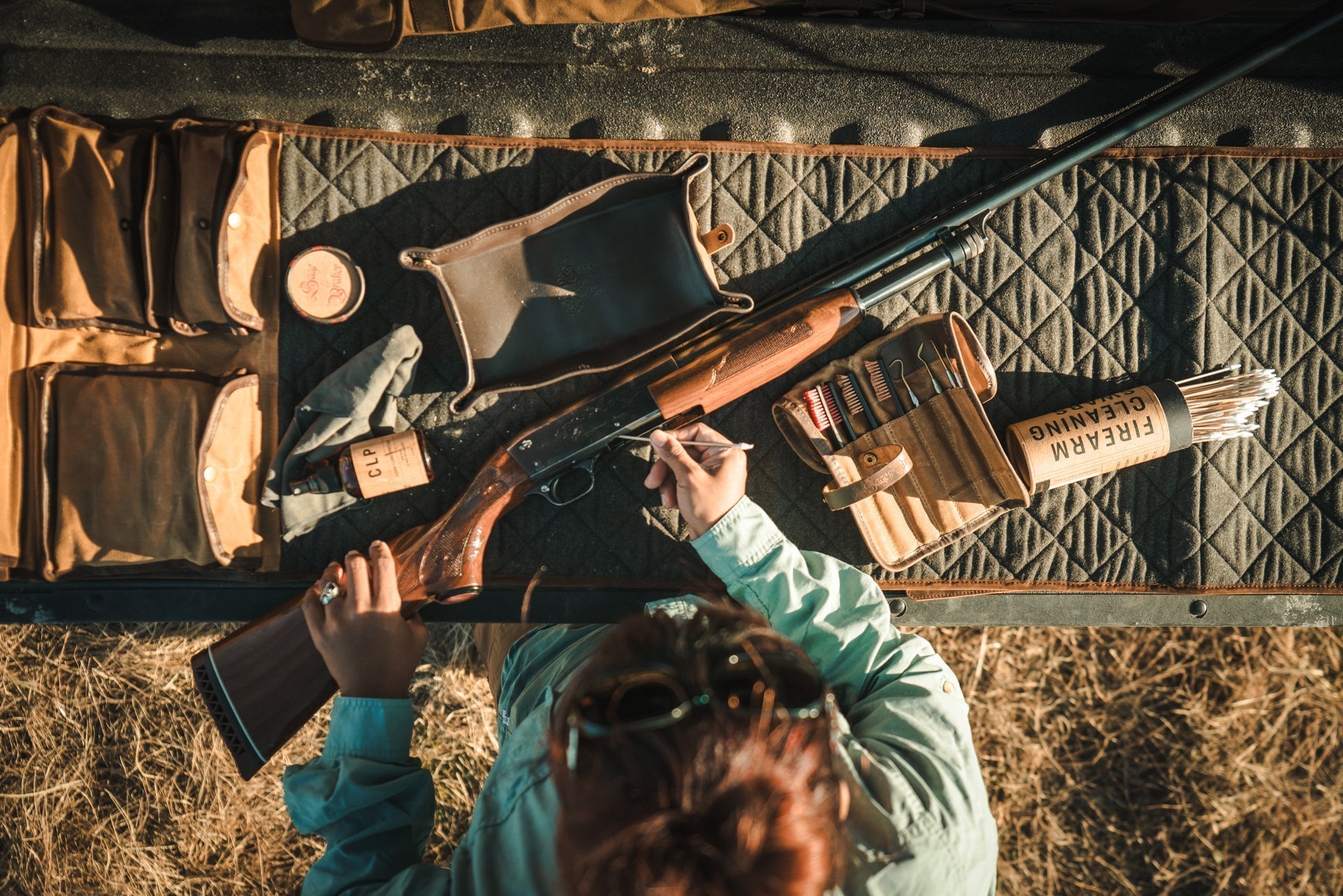 Upland Hunter Cleans Shotgun on Tailgate