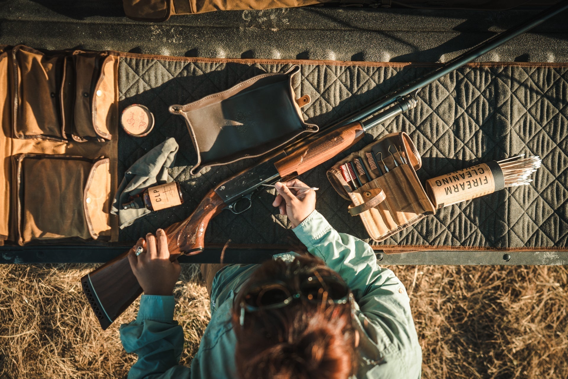 Upland Hunter Cleans Shotgun on Tailgate