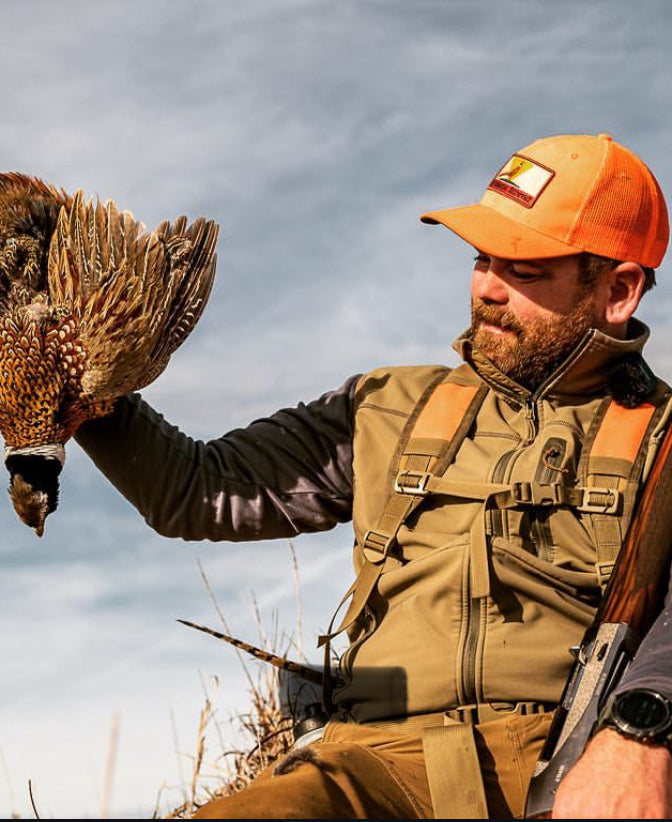 Successful hunter holding rooster