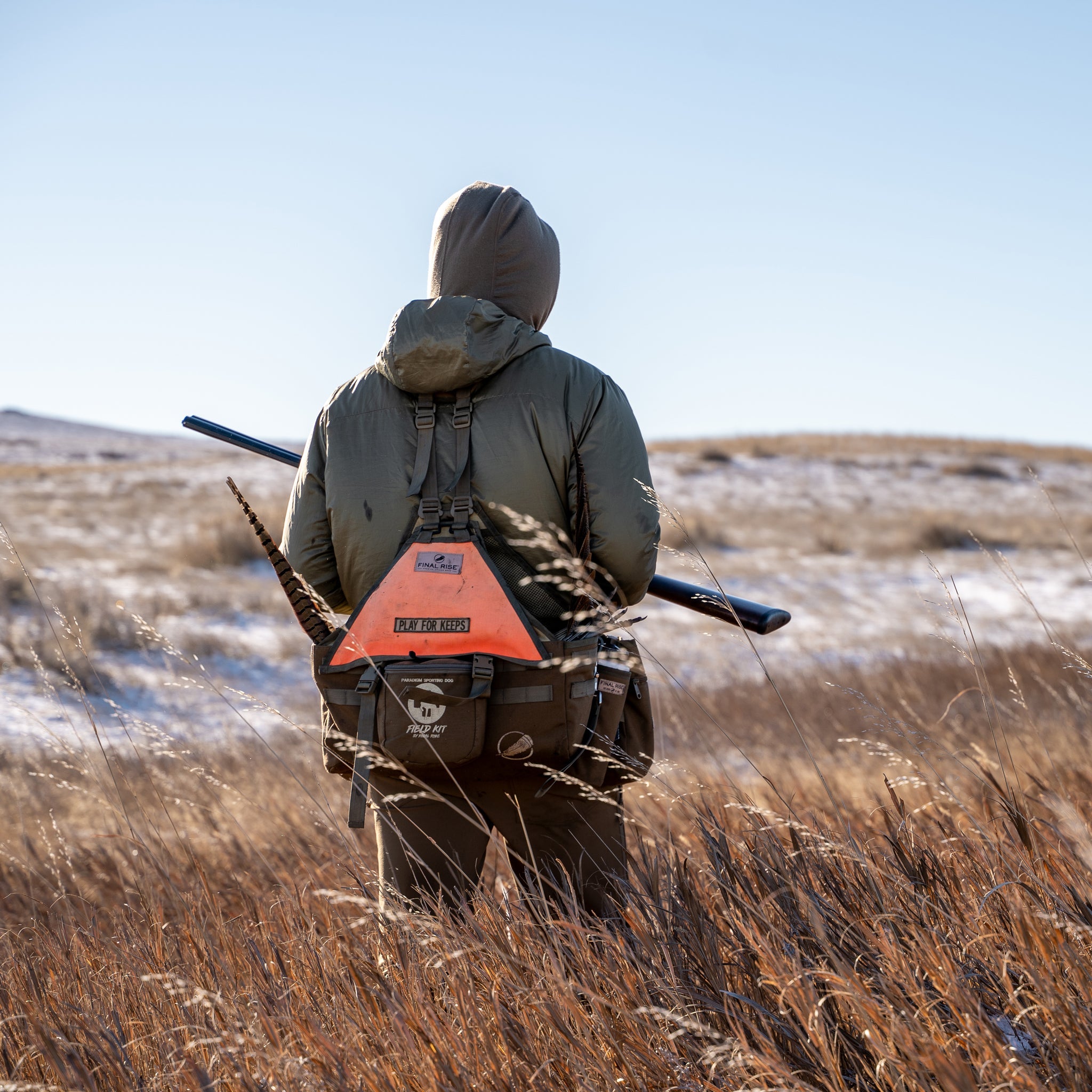 Successful hunter walking through field